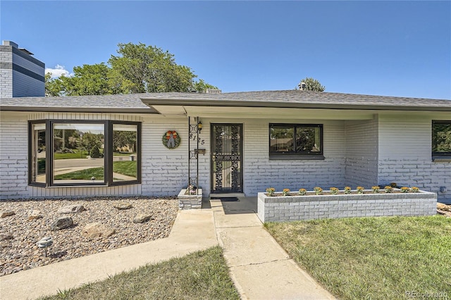 doorway to property featuring a yard