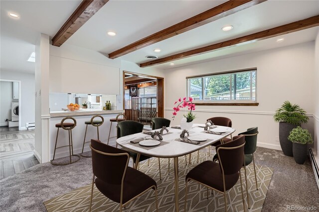 dining room featuring washer / clothes dryer, beamed ceiling, and baseboard heating