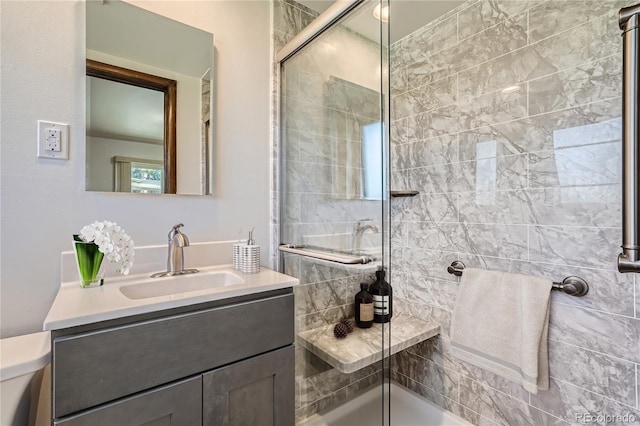 bathroom with vanity, a shower with shower door, and toilet