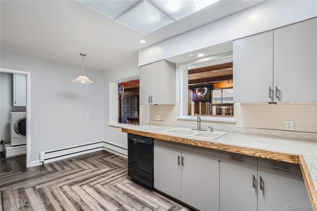 kitchen featuring a baseboard heating unit, washer / clothes dryer, sink, white cabinetry, and hanging light fixtures