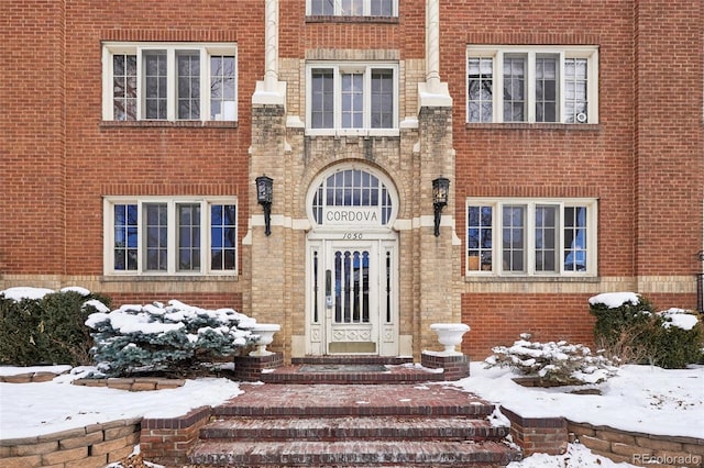 view of snow covered property entrance