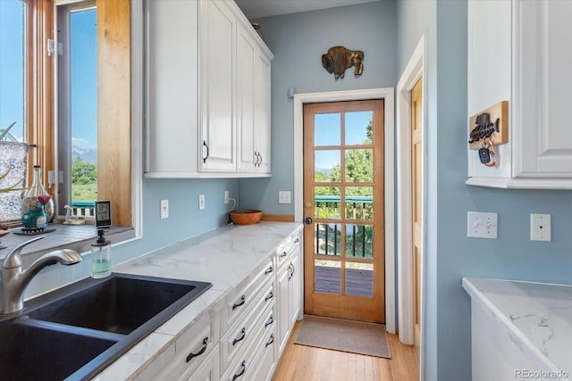10 N Price Park, Cotopaxi, CO 81223 - kitchen with white cabinetry, light wood-type flooring, and light stone countertops