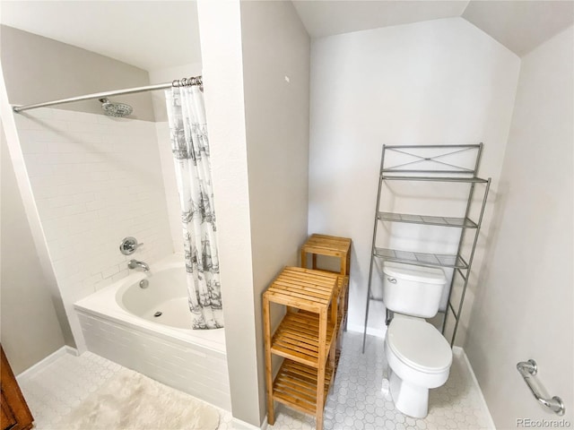 bathroom featuring toilet, shower / tub combo, vaulted ceiling, and tile patterned floors