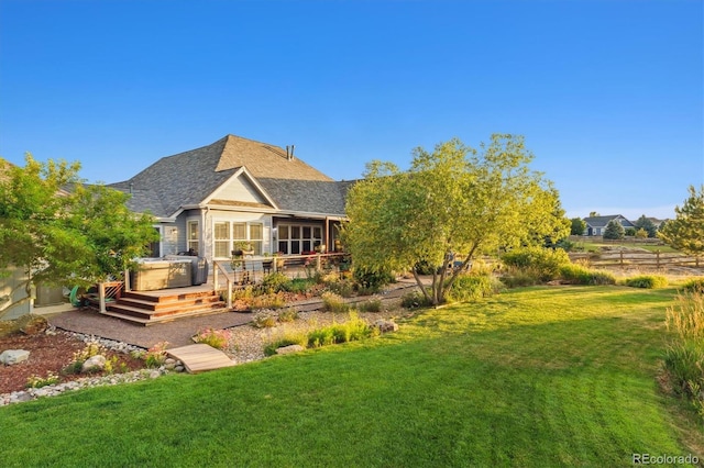 5463 Killen Ave, Castle Rock, CO 80104 - rear view of house featuring a lawn, a hot tub, a shingled roof, and a deck