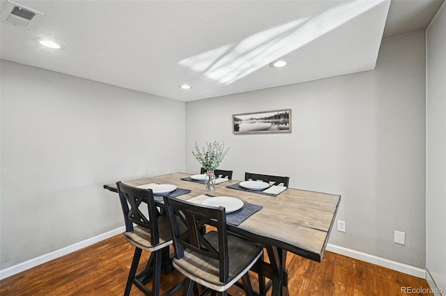 dining room featuring recessed lighting, wood finished floors, visible vents, and baseboards