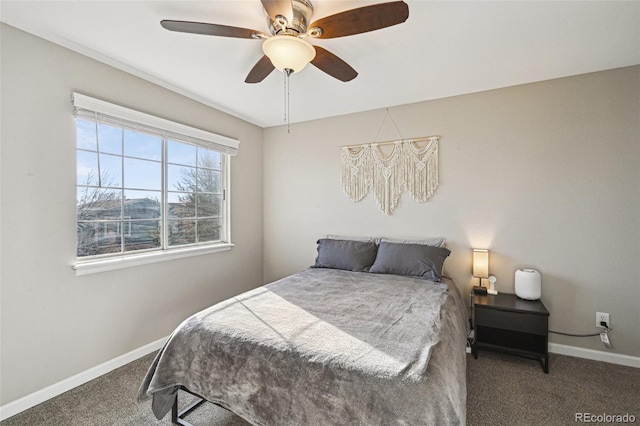 carpeted bedroom featuring baseboards and a ceiling fan