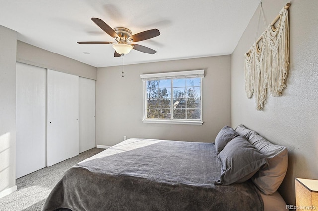 bedroom featuring ceiling fan, a closet, and carpet flooring