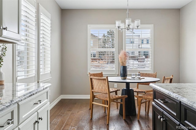 dining area featuring dark hardwood / wood-style floors and a chandelier