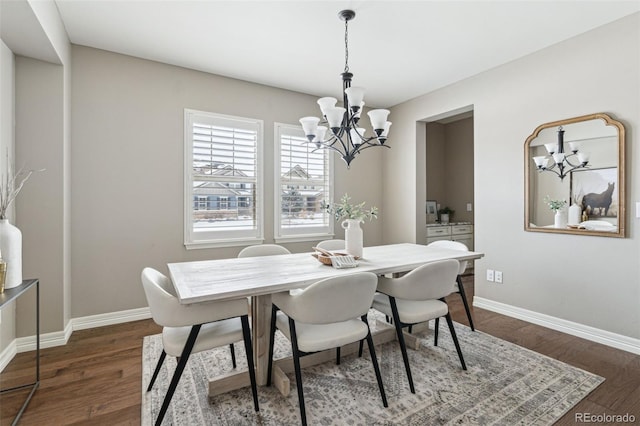 dining area featuring dark hardwood / wood-style flooring and a notable chandelier