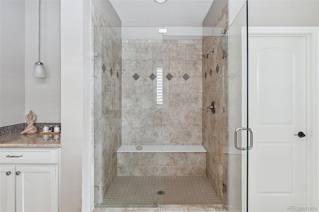 bathroom with an enclosed shower and vanity