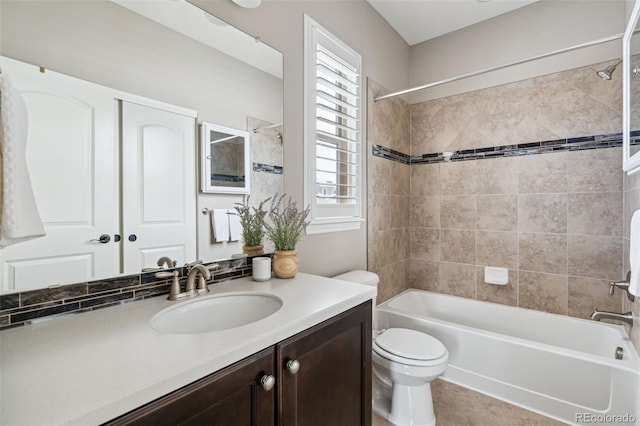 full bathroom featuring toilet, vanity, and tiled shower / bath