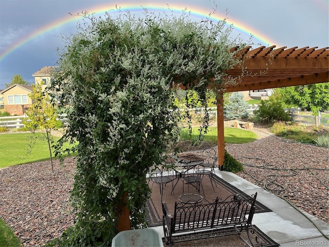 patio terrace at dusk with a pergola and a yard