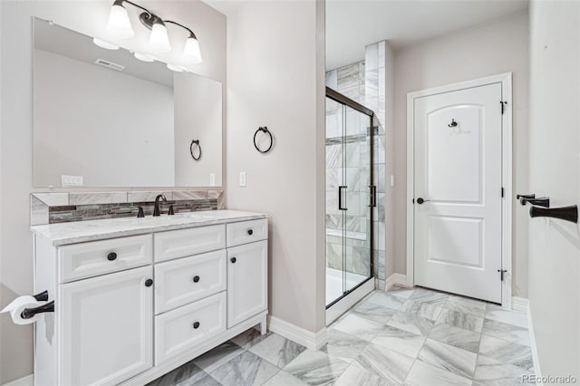 bathroom with vanity and a shower with door