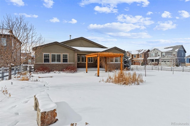 snow covered property featuring a pergola