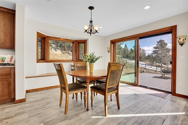 dining room featuring a notable chandelier, recessed lighting, light wood-type flooring, and baseboards