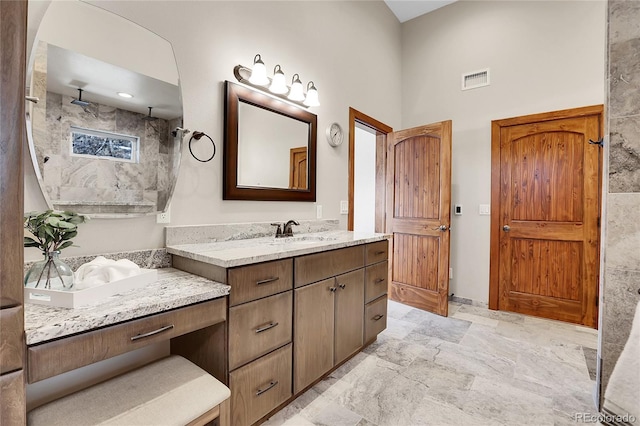 full bathroom with two vanities, a sink, and visible vents