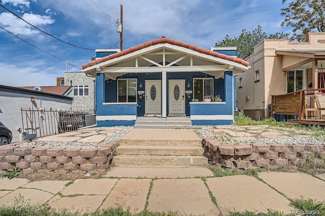 2838 Decatur St, Denver, CO 80211 - view of front of home featuring a tiled roof, stucco siding, and covered porch