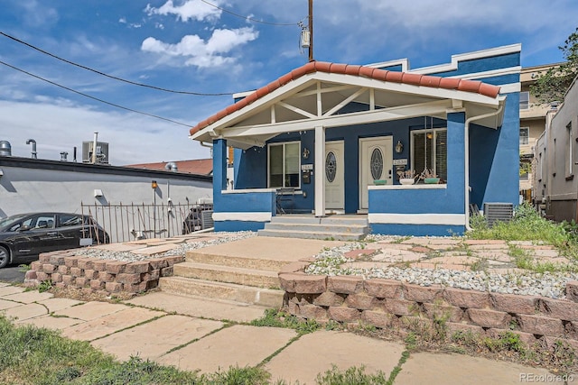 2838 Decatur St, Denver, CO 80211 - view of front of house with a tiled roof, a porch, and stucco siding