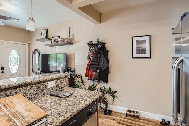 2838 Decatur St, Denver, CO 80211 - kitchen with light wood-style flooring, baseboards, stainless steel fridge, light stone counters, and pendant lighting