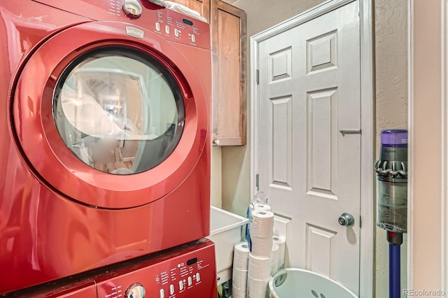 2838 Decatur St, Denver, CO 80211 - laundry room with stacked washer / drying machine, cabinet space, and a textured wall