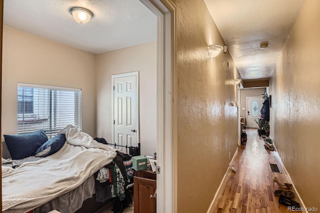 2838 Decatur St, Denver, CO 80211 - bedroom featuring wood finished floors, baseboards, and a textured wall