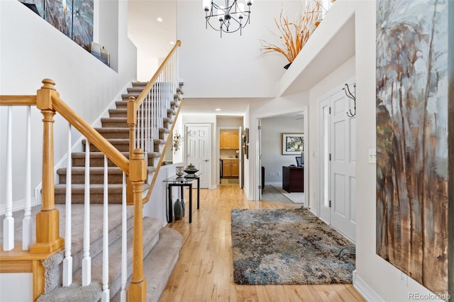 foyer entrance featuring a high ceiling and light wood-type flooring