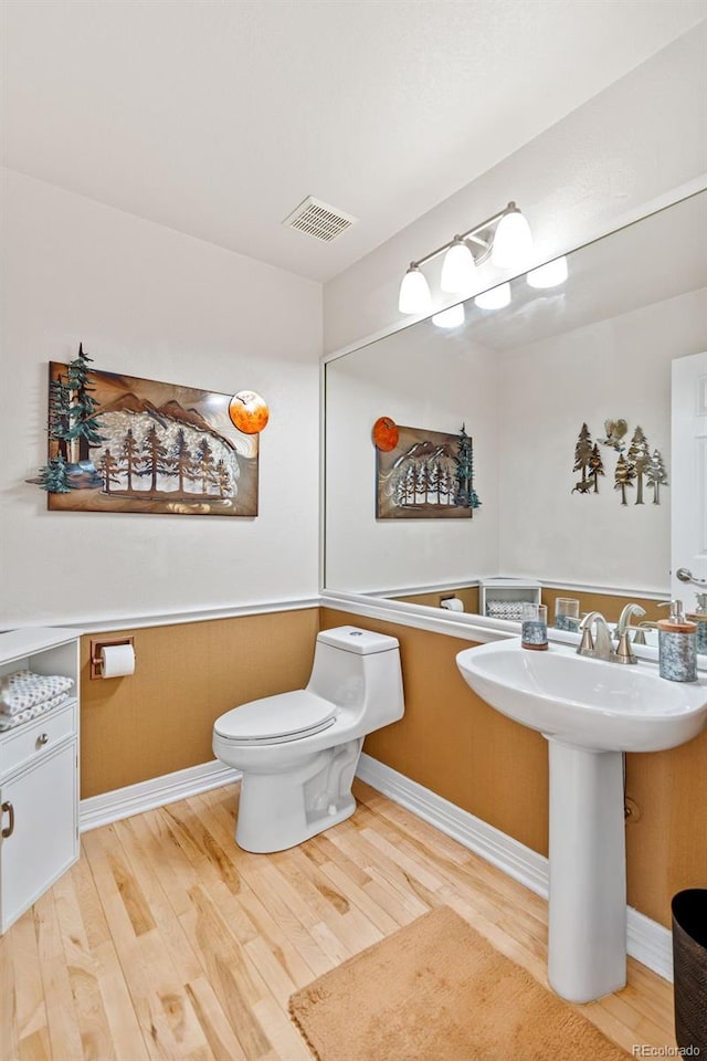 bathroom featuring sink, wood-type flooring, and toilet