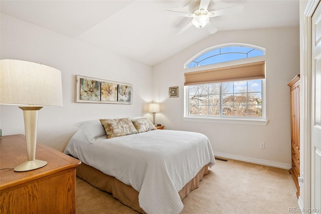 bedroom featuring ceiling fan, vaulted ceiling, and light carpet