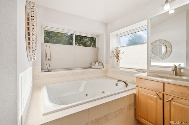 bathroom featuring vanity and tiled tub