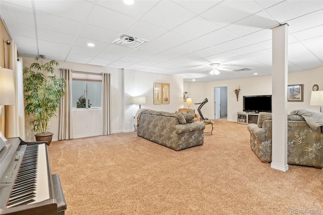 living room featuring ceiling fan, a paneled ceiling, and light carpet