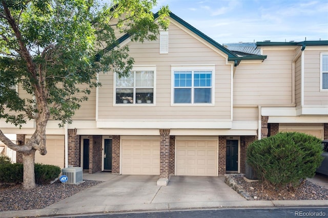 view of front of house featuring central AC and a garage