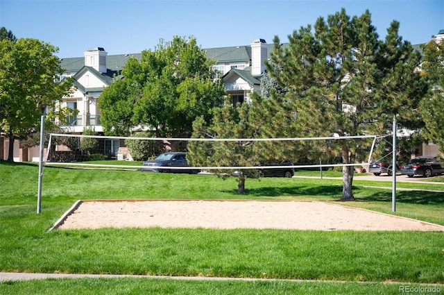 view of home's community featuring a lawn and volleyball court