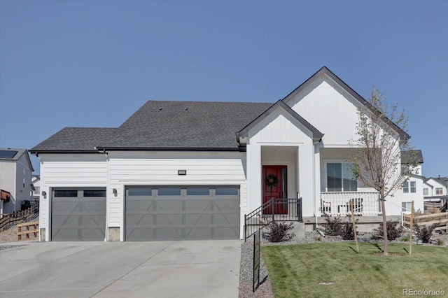 view of front of property with a front yard and a garage