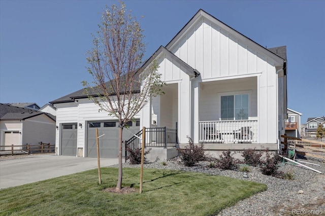 view of front of property with a porch, a front yard, and a garage