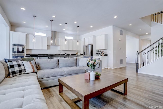 living room featuring light hardwood / wood-style floors and sink