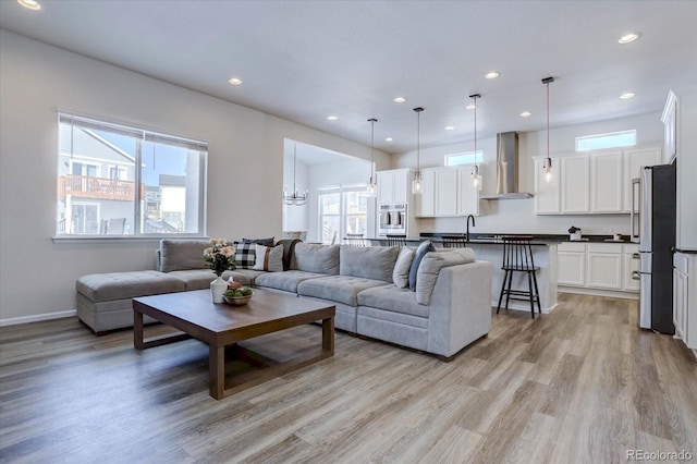 living room with light wood-type flooring and sink