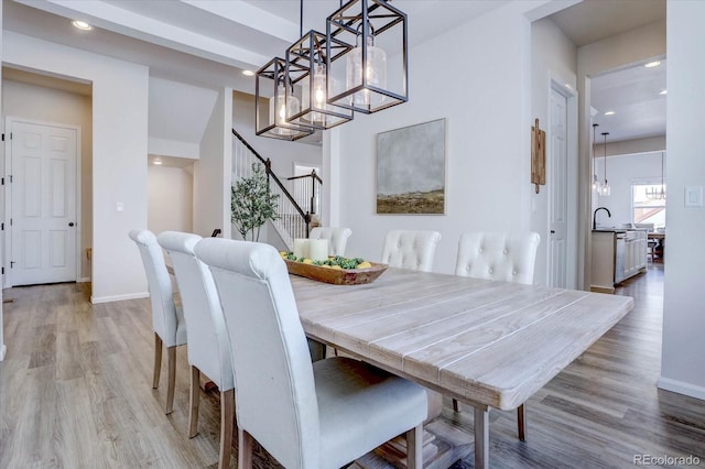 dining room featuring light wood-type flooring and sink