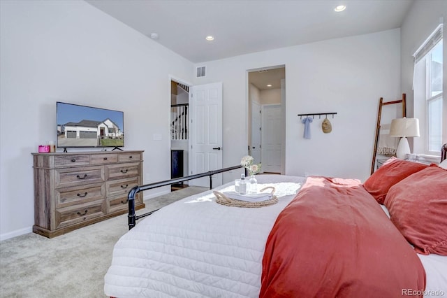 bedroom featuring light colored carpet