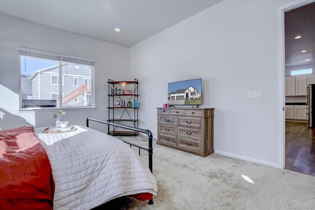 carpeted bedroom featuring stainless steel fridge