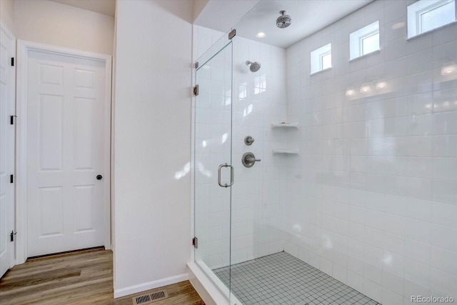 bathroom with walk in shower and wood-type flooring