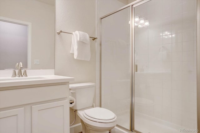 bathroom featuring toilet, an enclosed shower, and vanity