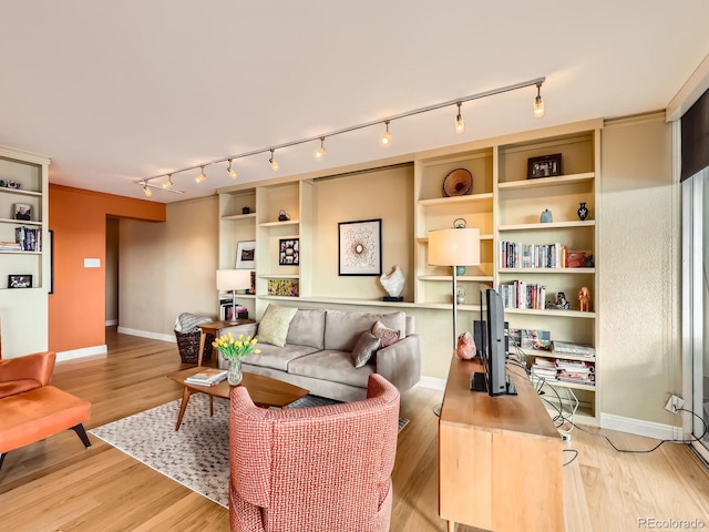 living area featuring light wood finished floors and baseboards