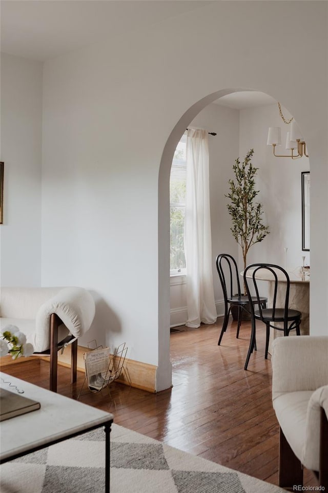 461 S Sherman St, Denver, CO 80209 - living area featuring arched walkways, wood finished floors, and a chandelier