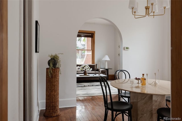 461 S Sherman St, Denver, CO 80209 - dining area featuring arched walkways, dark wood-style flooring, and a chandelier