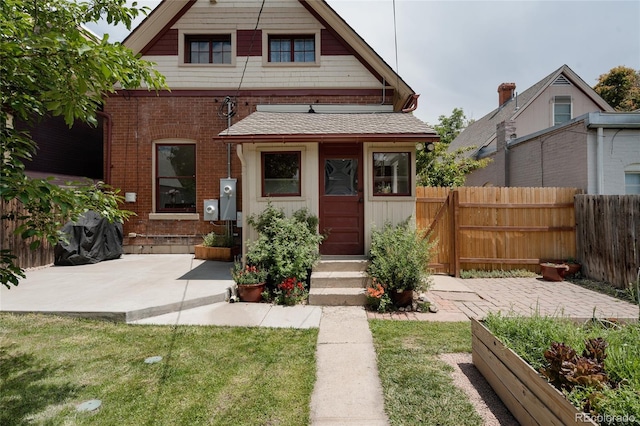 461 S Sherman St, Denver, CO 80209 - view of front of home with a patio area, entry steps, brick siding, and roof with shingles