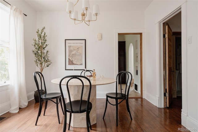 461 S Sherman St, Denver, CO 80209 - dining space featuring wood finished floors and a chandelier