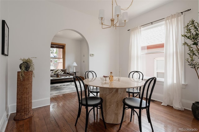 461 S Sherman St, Denver, CO 80209 - dining area featuring arched walkways, dark wood-style floors, and a chandelier