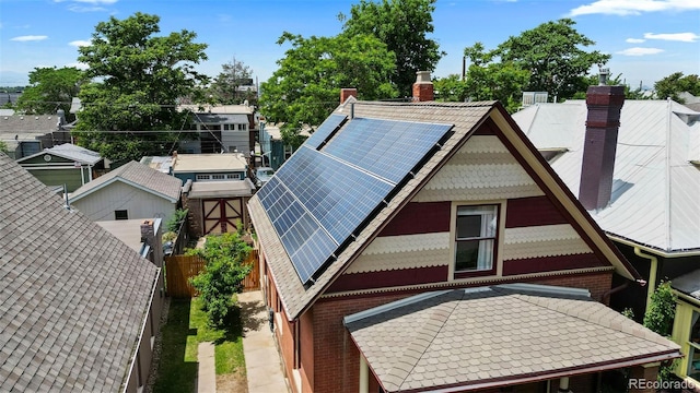 461 S Sherman St, Denver, CO 80209 - exterior space featuring a chimney and roof mounted solar panels