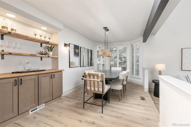 5814 Cole Way, Arvada, CO 80004 - dining space featuring light wood-style floors, a dry bar, and recessed lighting