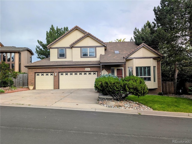 5814 Cole Way, Arvada, CO 80004 - traditional-style house featuring driveway, brick siding, a tiled roof, and a garage